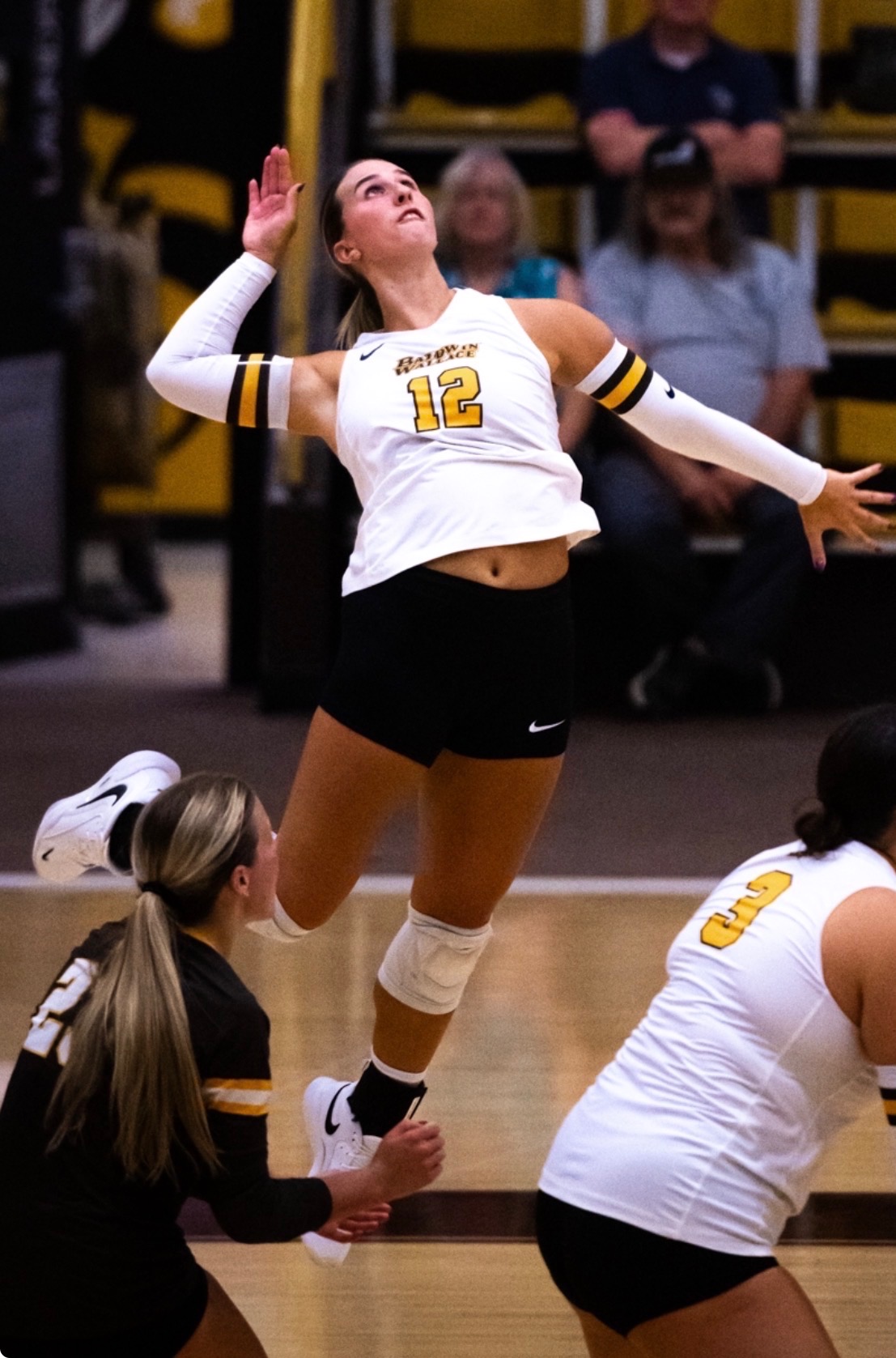 Volleyball player in custom team uniform spiking the ball